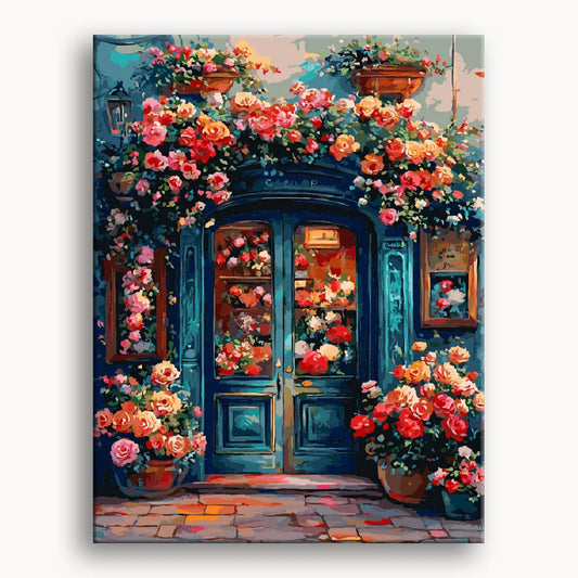 A colorful painting of flowers decorates the door of a charming flower shop.